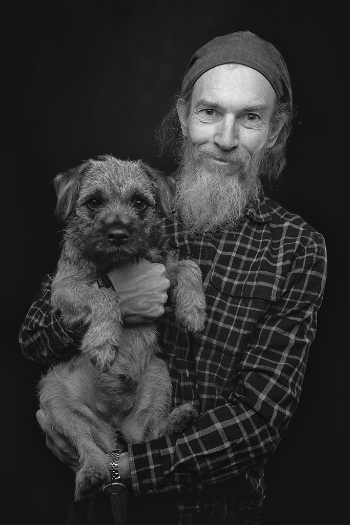 image of bearded man with his border terrier dog